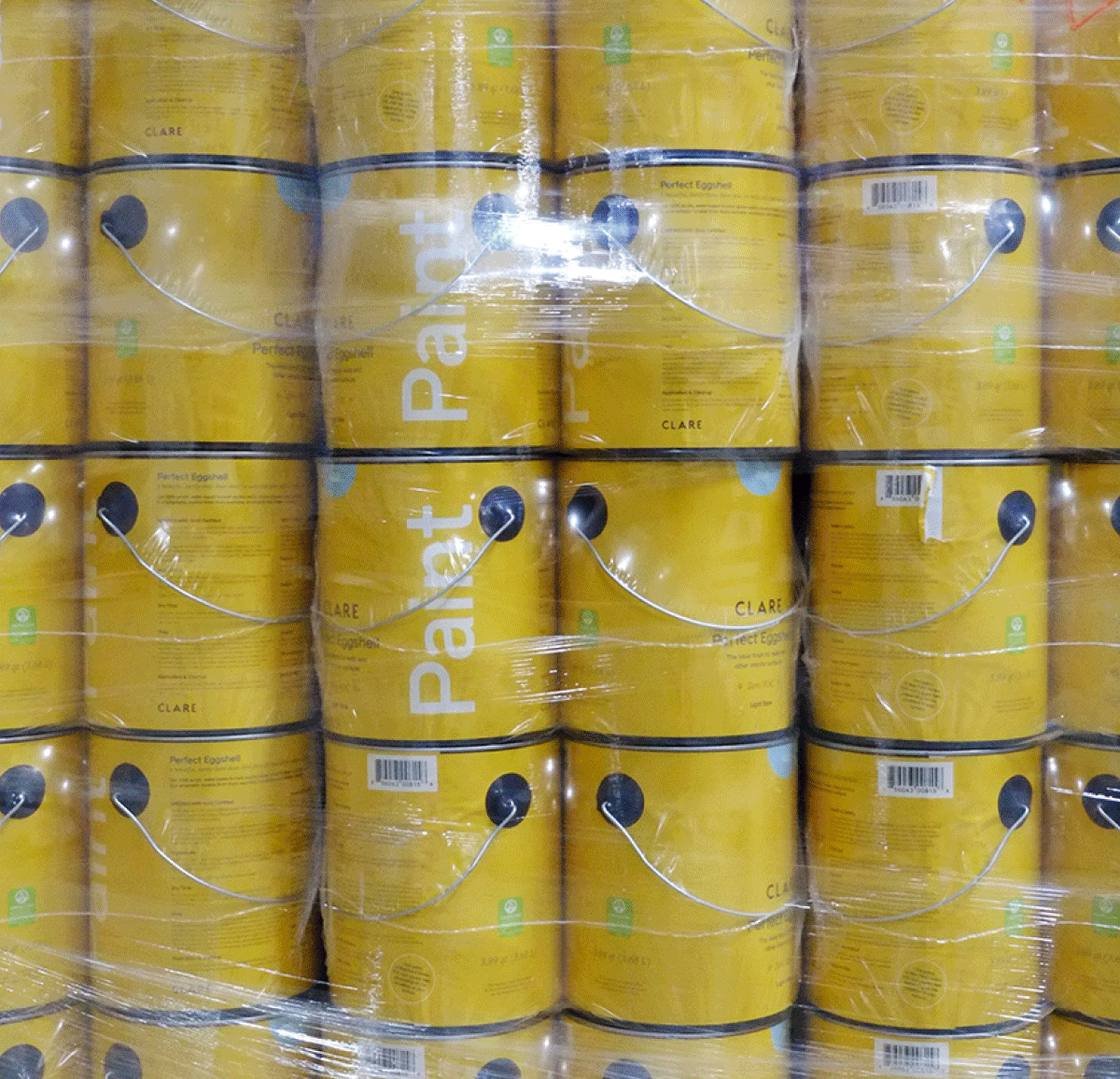 Pallets of Clare paint cans wrapped in film in the warehouse