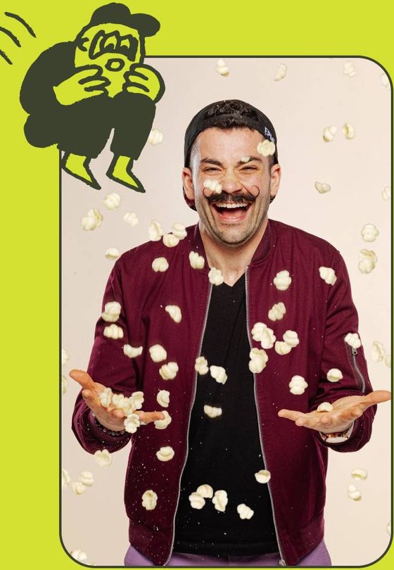Chef Joe Sasto laughing under a shower of pasta shapes