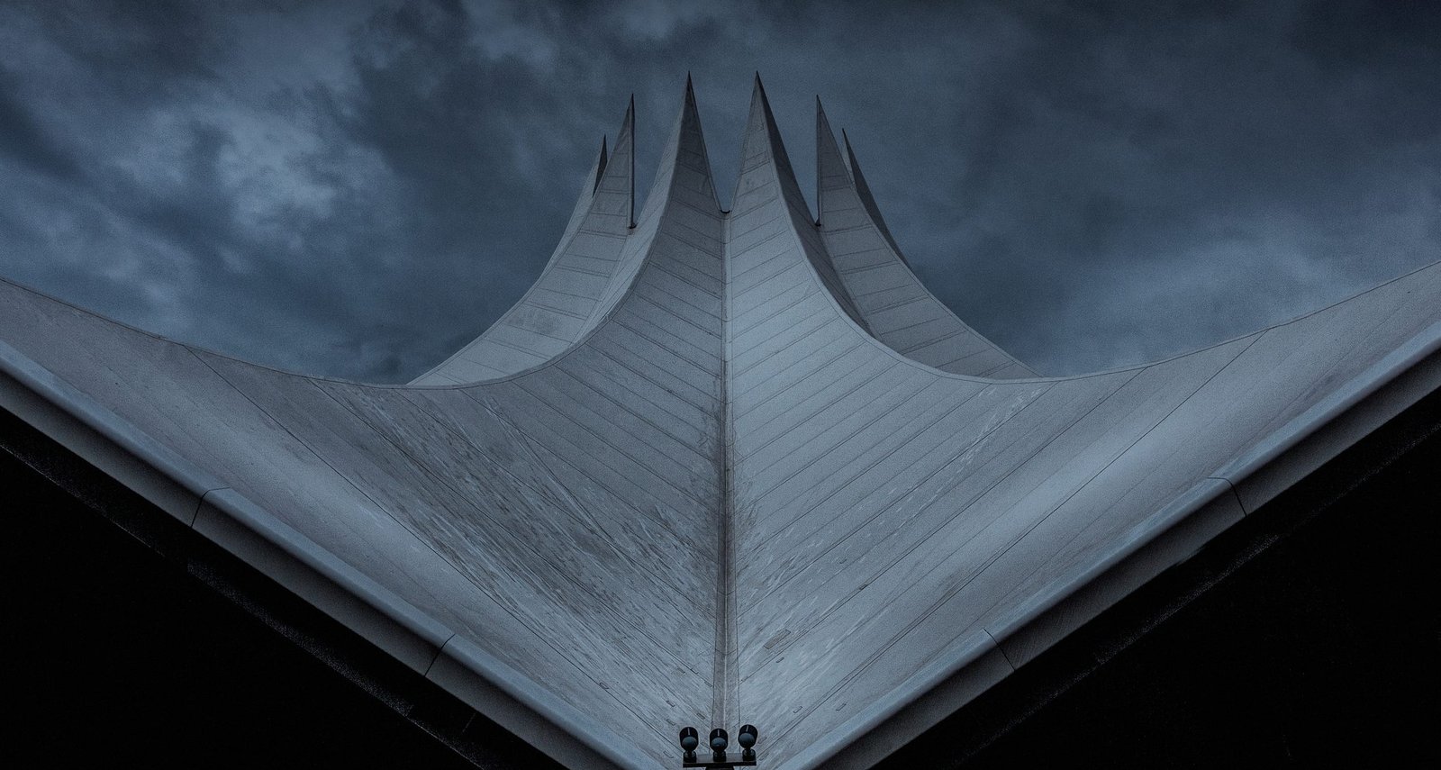 Steel frame of a building under construction against an overcast sky