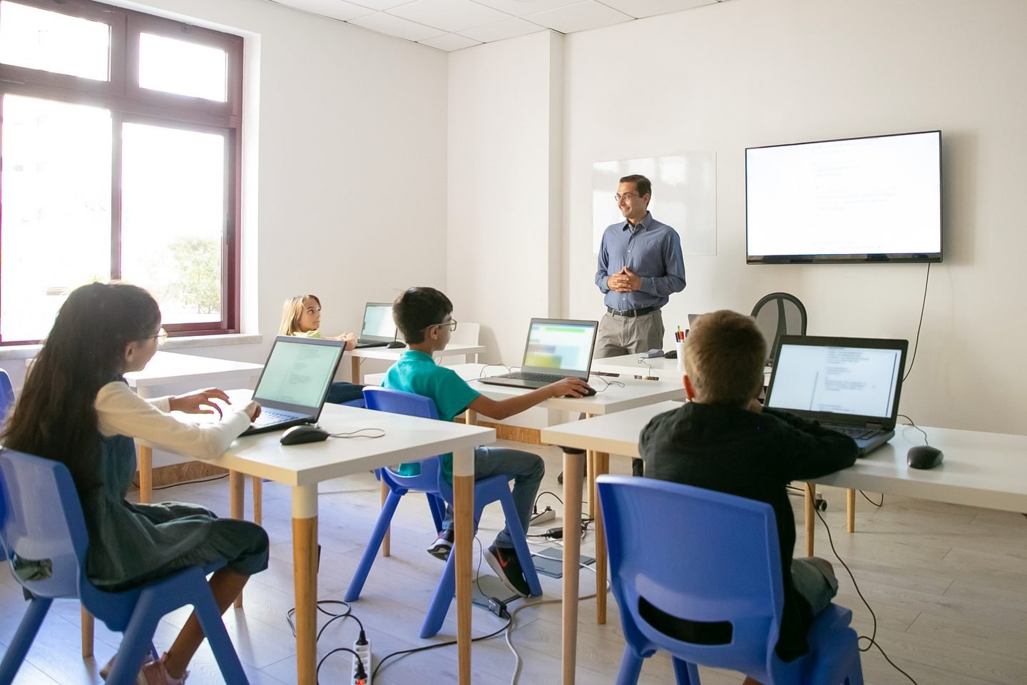 Teacher explaining a lesson in a bright classroom