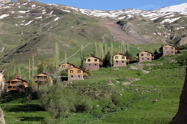 Green mountain valley with scattered houses