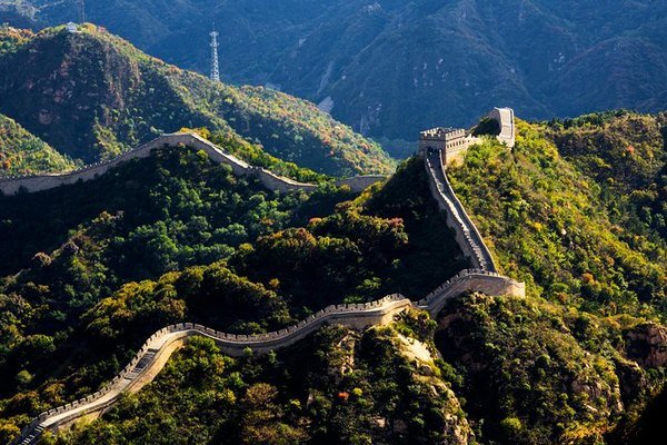 The Great Wall of China winding along a green ridge