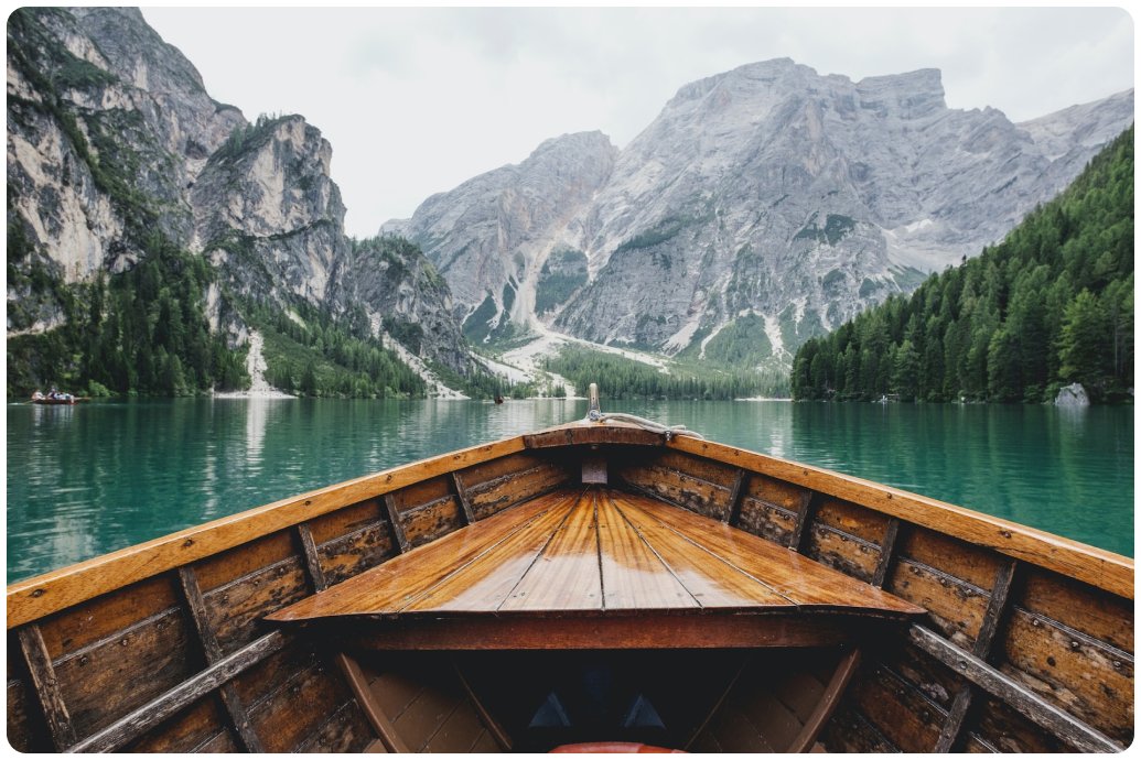 Boat traveling through a snowy Scandinavian winter landscape