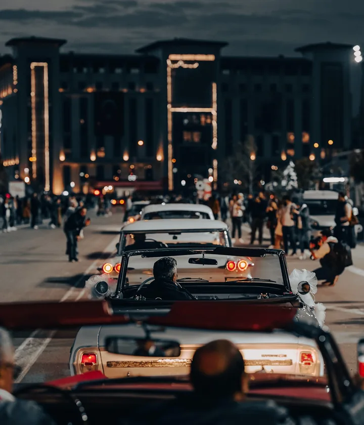 Yellow cabs and traffic on a city avenue at dusk