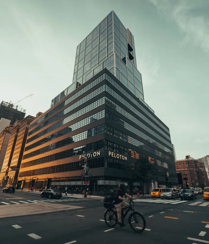 Glass office tower above a crossing with a cyclist