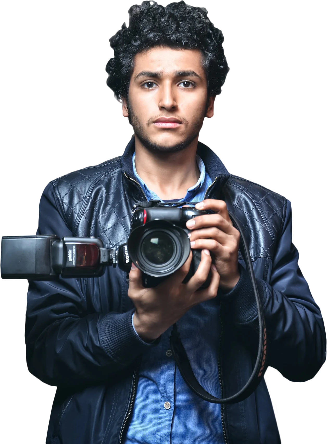 William Smith in a leather jacket holding a camera with a flash